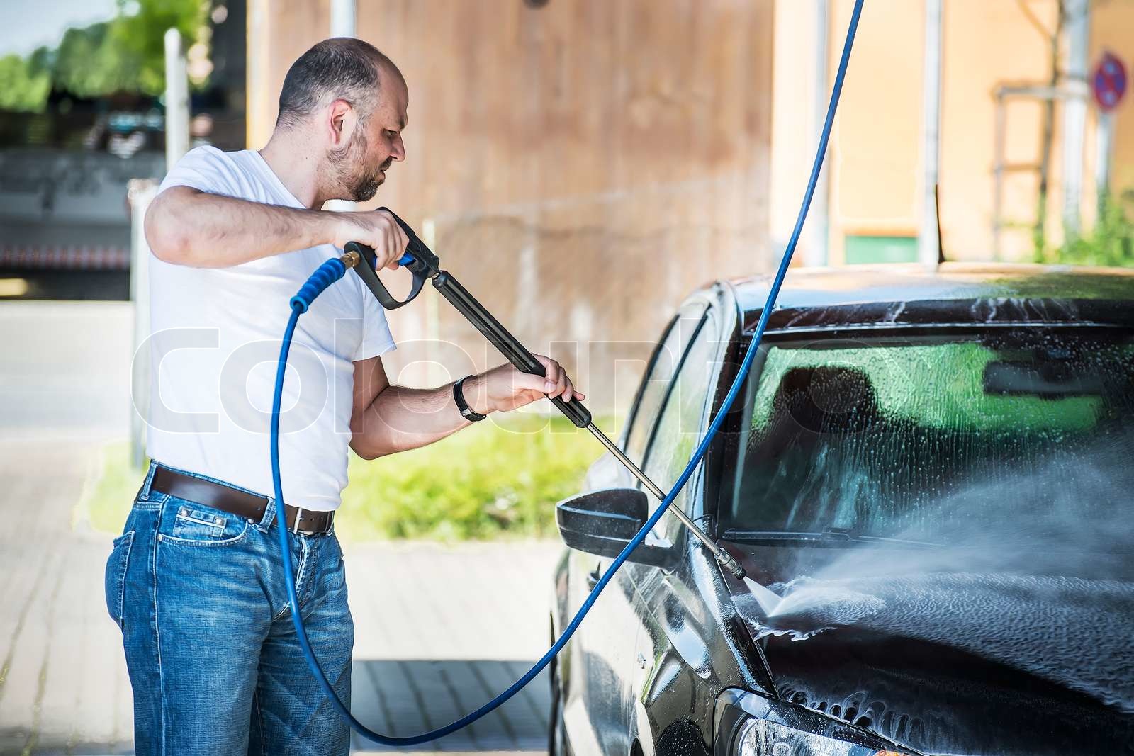 Man washing his car Stock image Colourbox