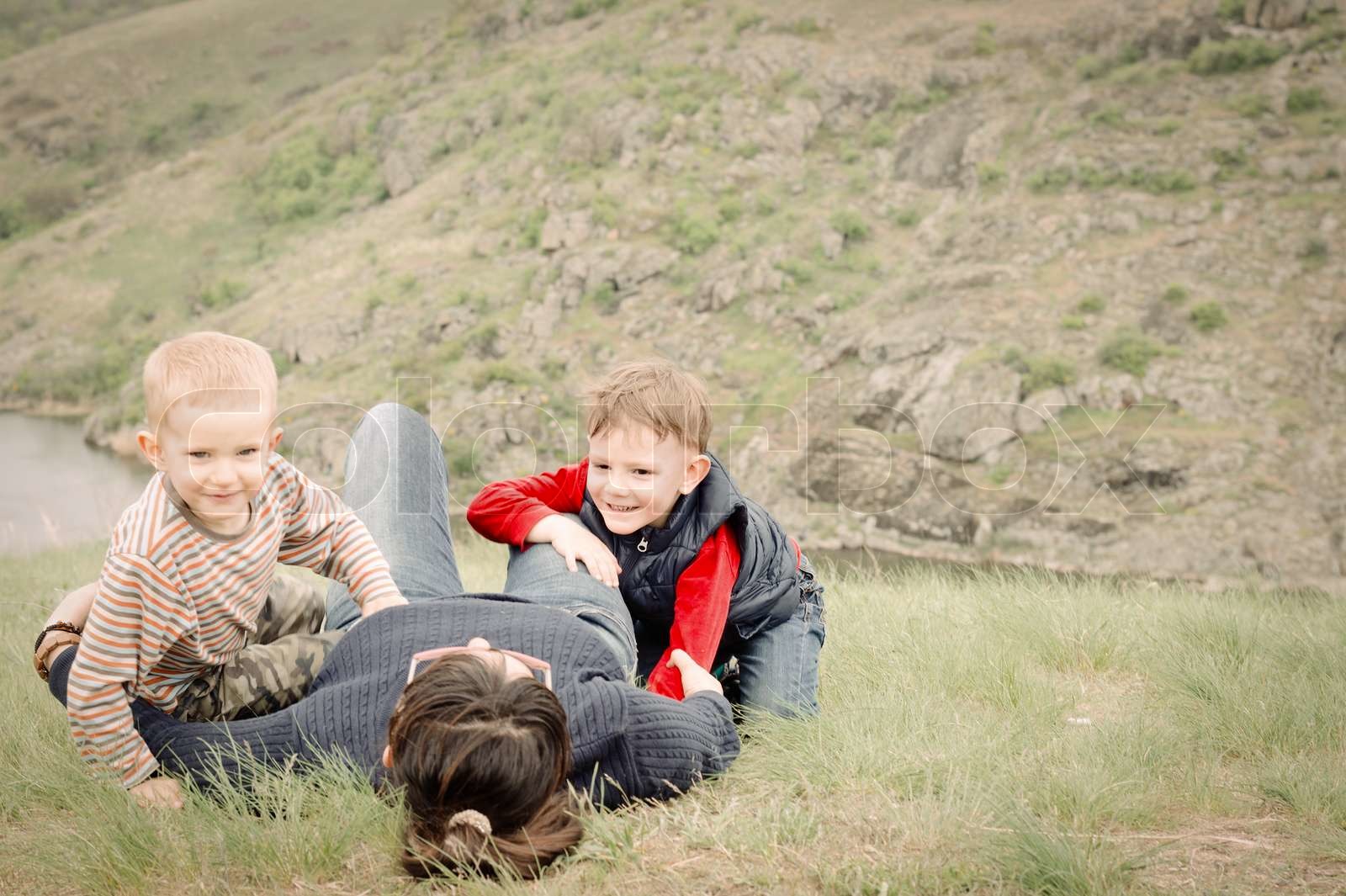 Two young boys playing with their mother | Stock image | Colourbox