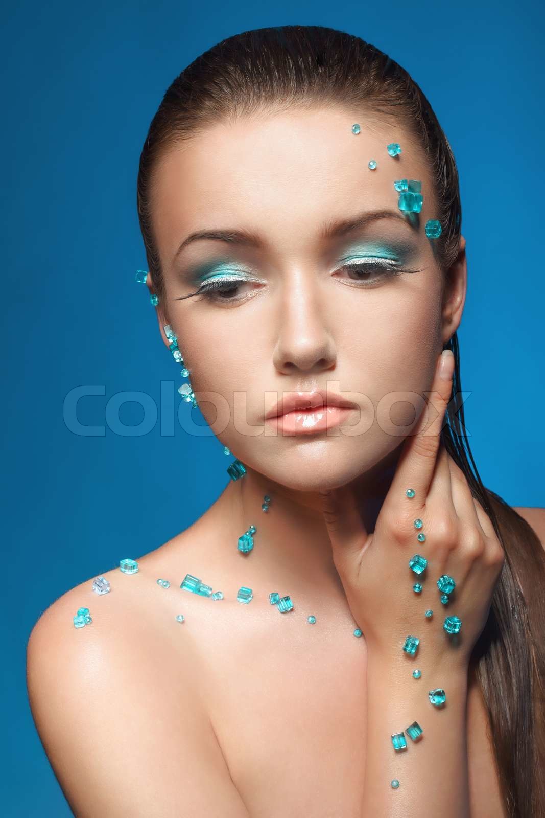Beautiful naked young woman covered with blue crystals | Stock image