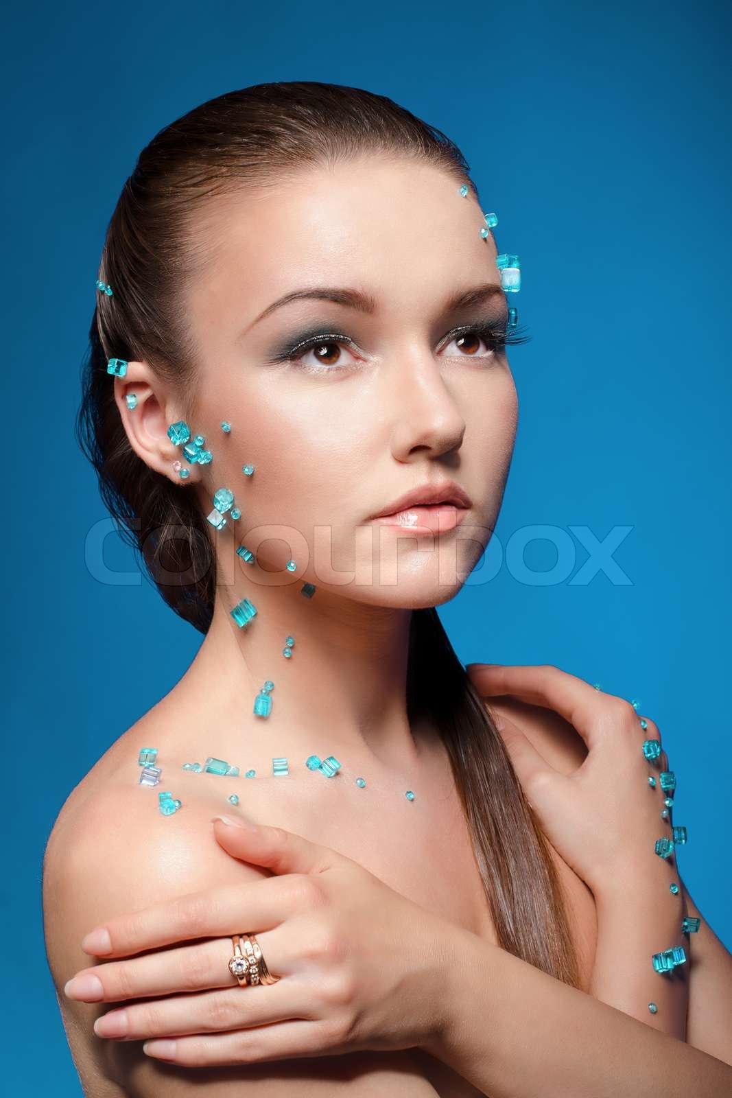 Beautiful naked young woman covered with blue crystals Stock image Colourbox