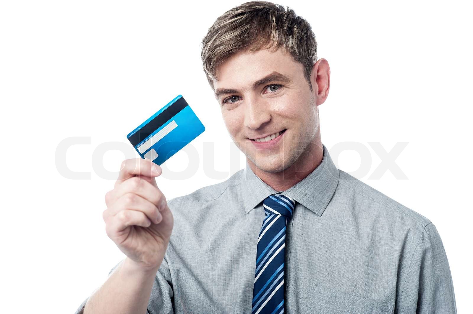 Smiling corporate guy showing his debit card | Stock image | Colourbox