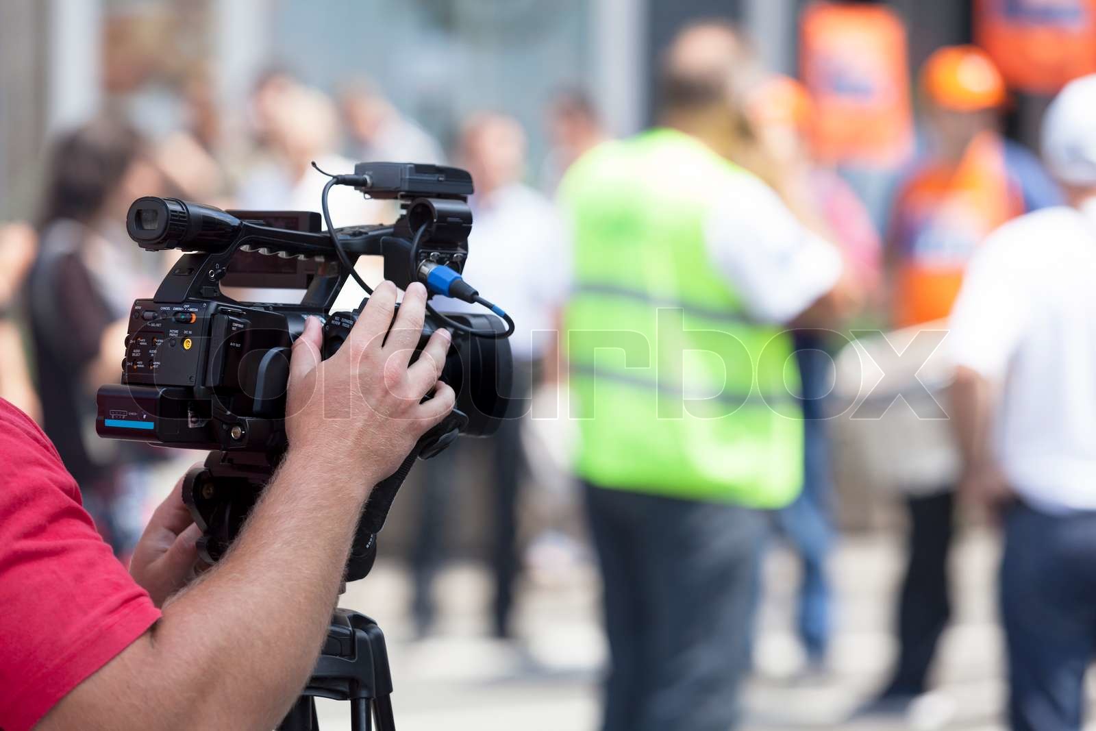 Filming an event with a video camera Stock image Colourbox