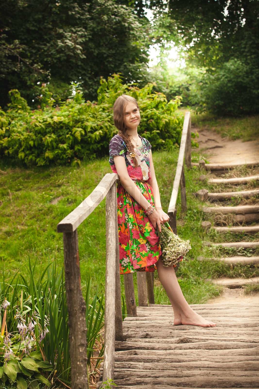 russian country girl with bunch flowers on wooden bridge | Stock image ...