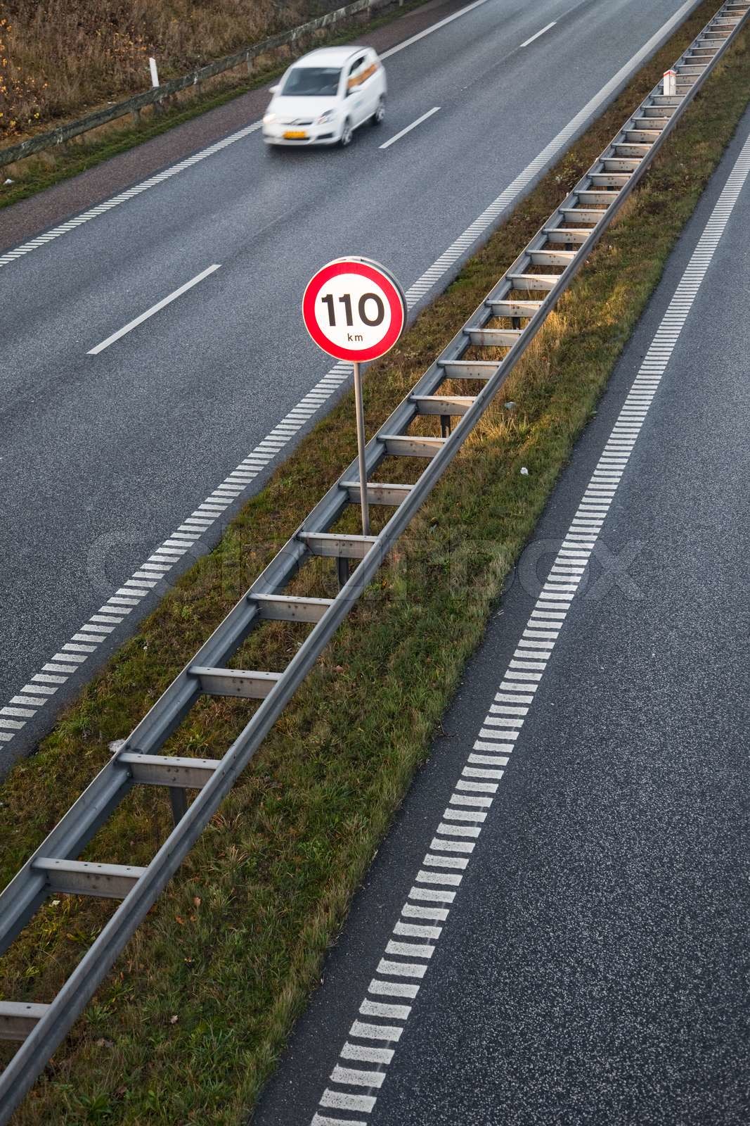 Speed limit (110) sign in a motor highway in Denmark | Stock image
