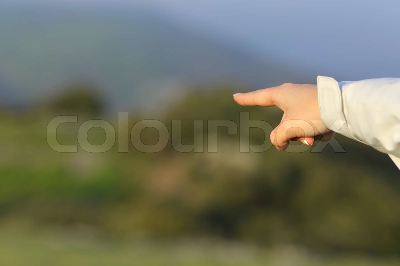 Hiker hand pointing at the mountain | Stock image | Colourbox