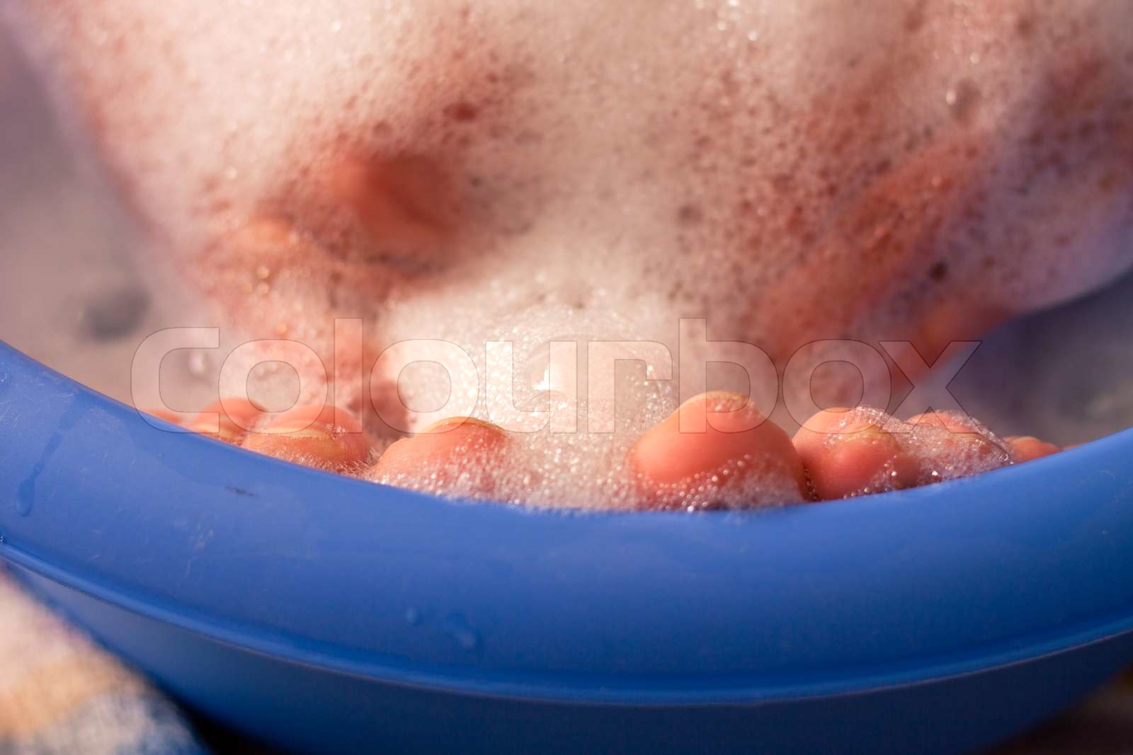 Female feet in soap bath | Stock image | Colourbox
