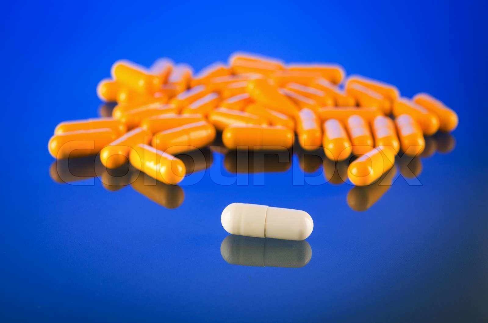 one white capsule on glass Stock image Colourbox