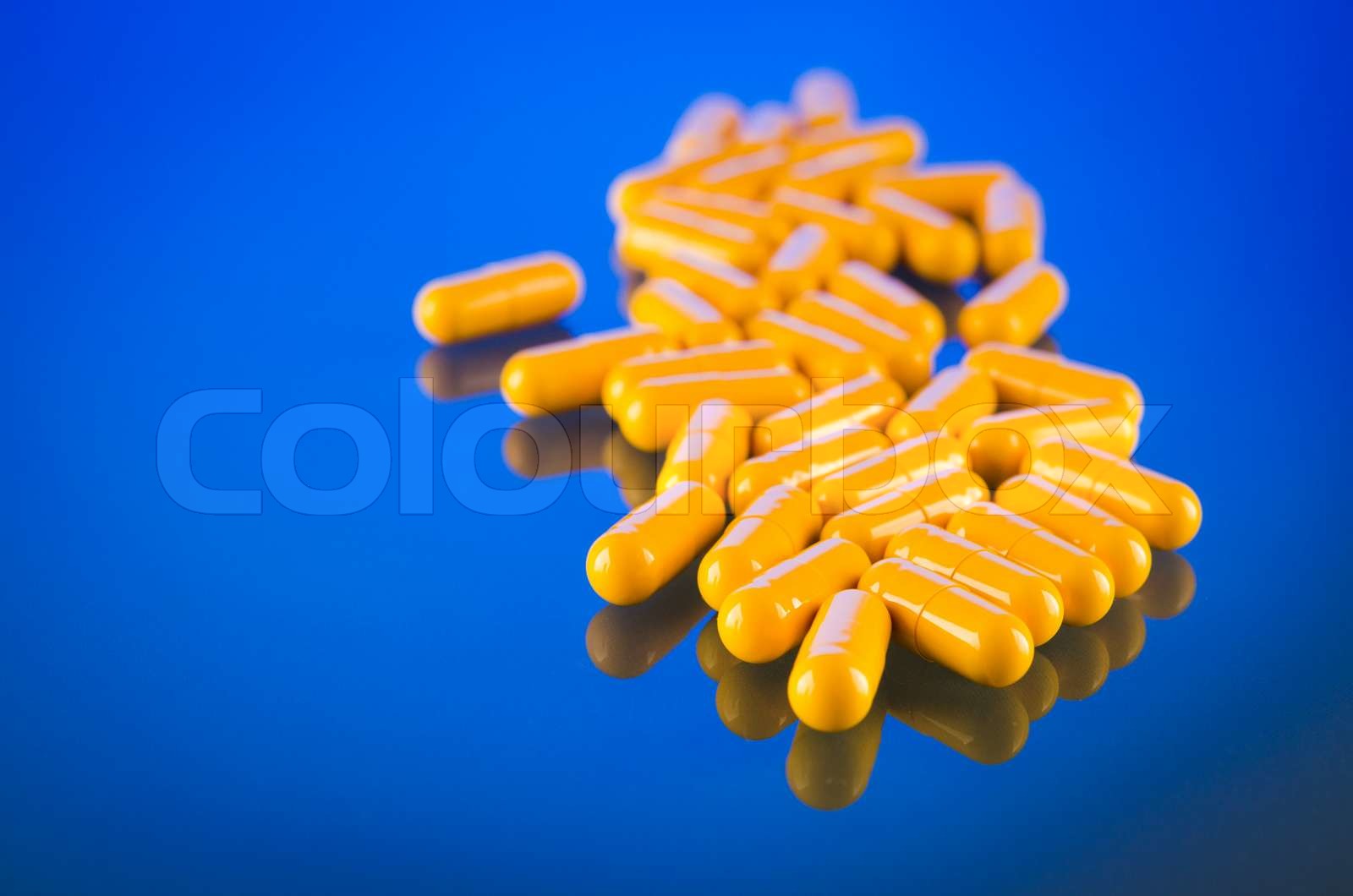 pile of yellow capsule Stock image Colourbox