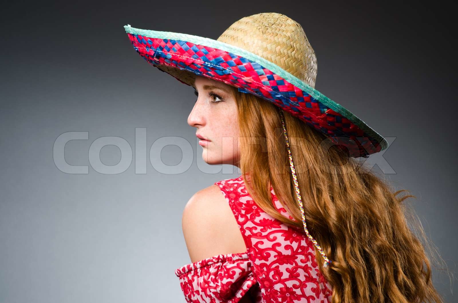 Mexican woman wearing red sombrero | Stock image | Colourbox