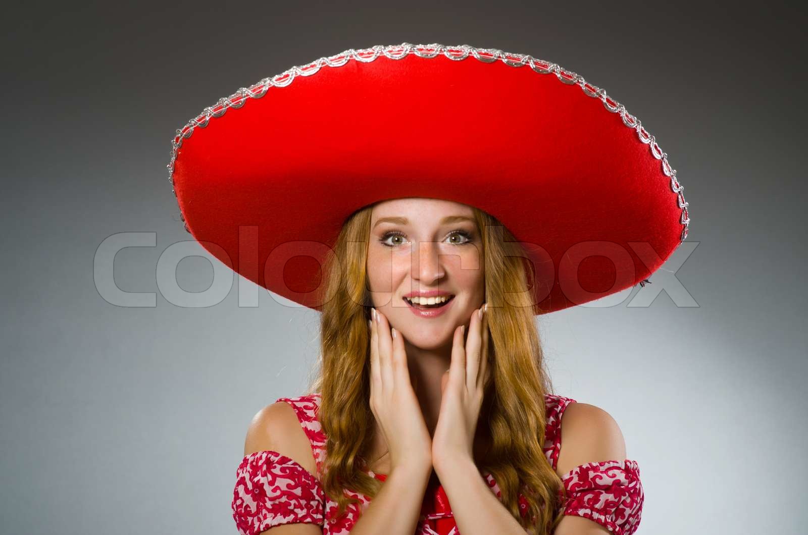 Mexican woman wearing red sombrero | Stock image | Colourbox