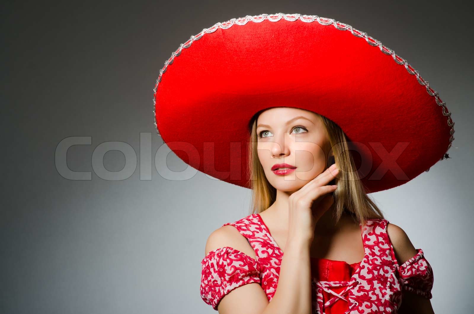 Woman wearing nice red sombrero | Stock image | Colourbox