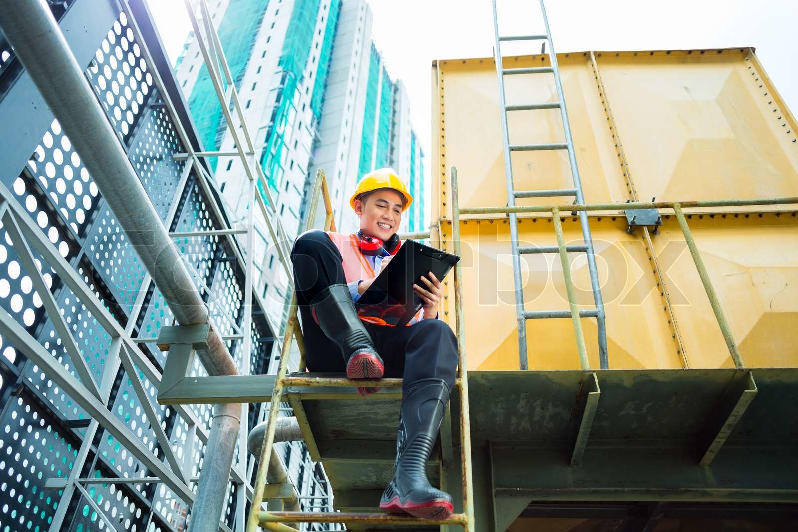 Asian Indonesian Construction Worker On Building Site Stock Image