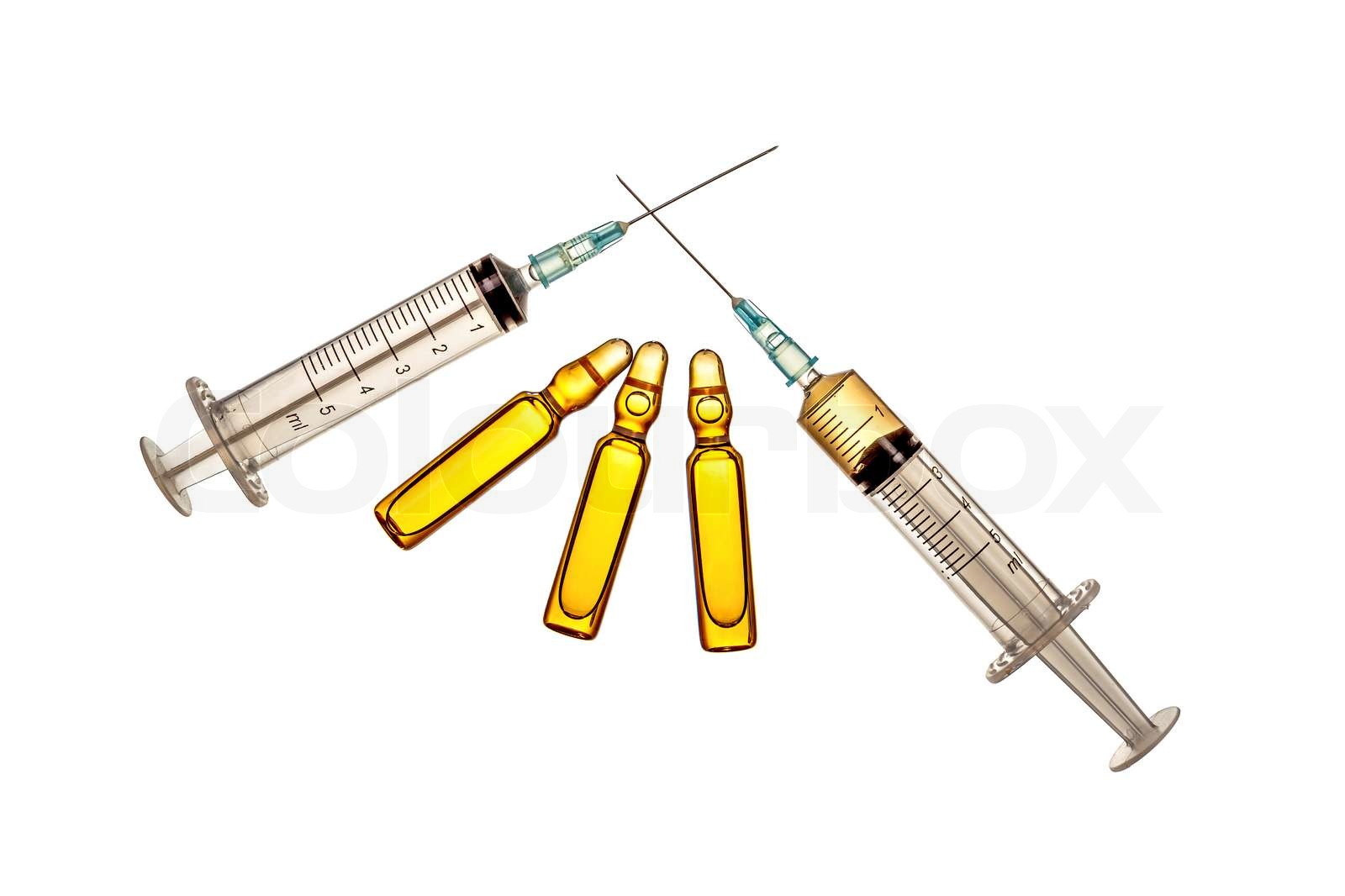 Crossed syringes and yellow ampules Stock image Colourbox