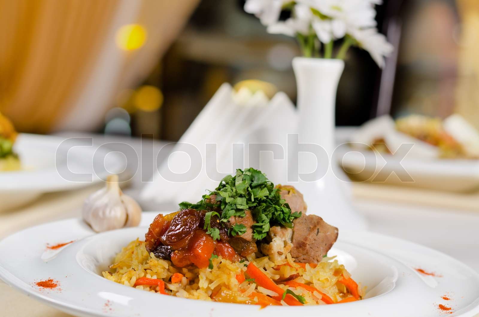 Roast meat on a bed on savory rice Stock image Colourbox