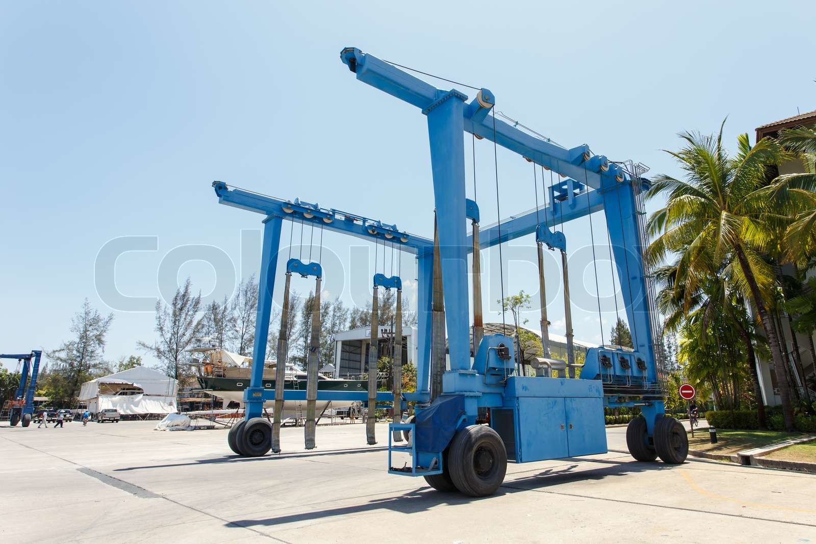 Crane lifting boats at harbor Stock image Colourbox