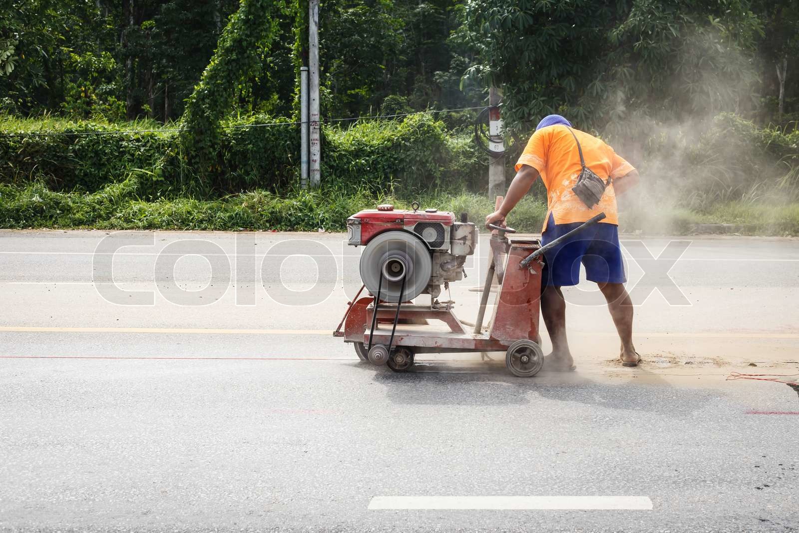 Cutting asphalt road for repair by hydraulic driven angle grinder