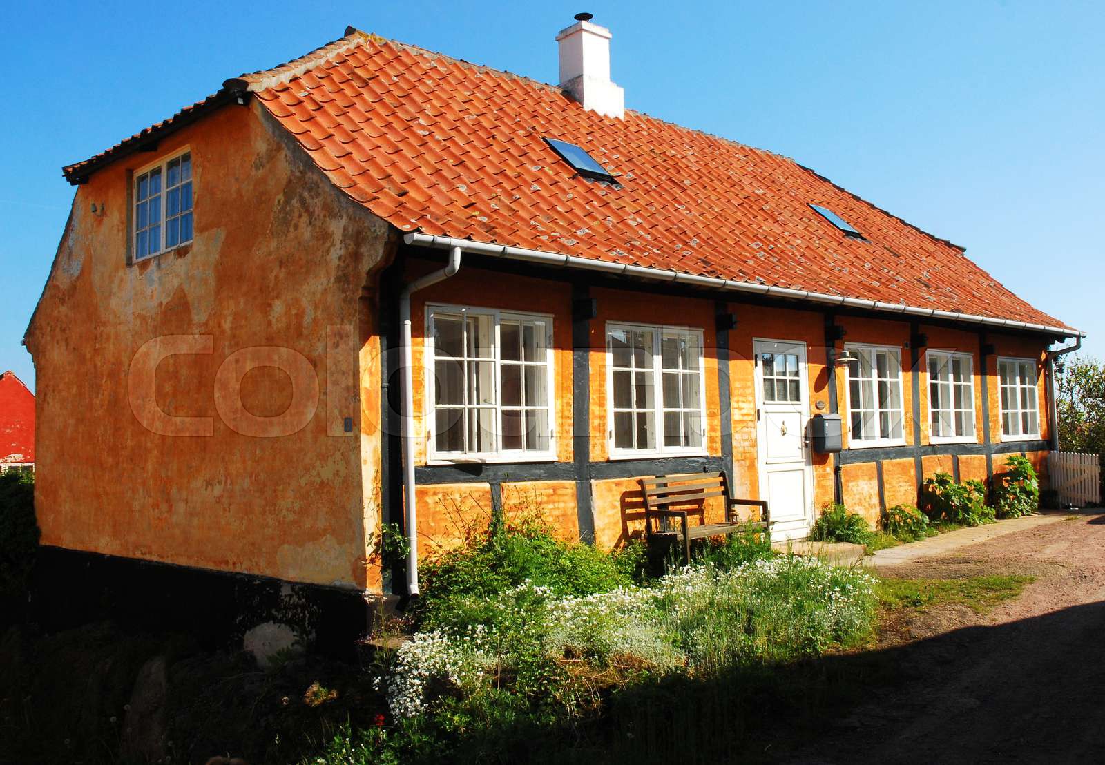 Ochre Coloured Timberframed House in Svaneke Stock image Colourbox