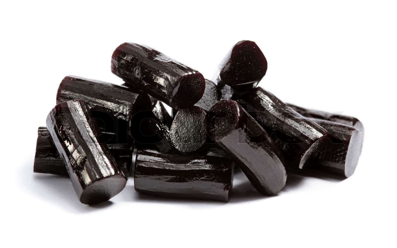 Pieces of black liquorice on white Stock image Colourbox