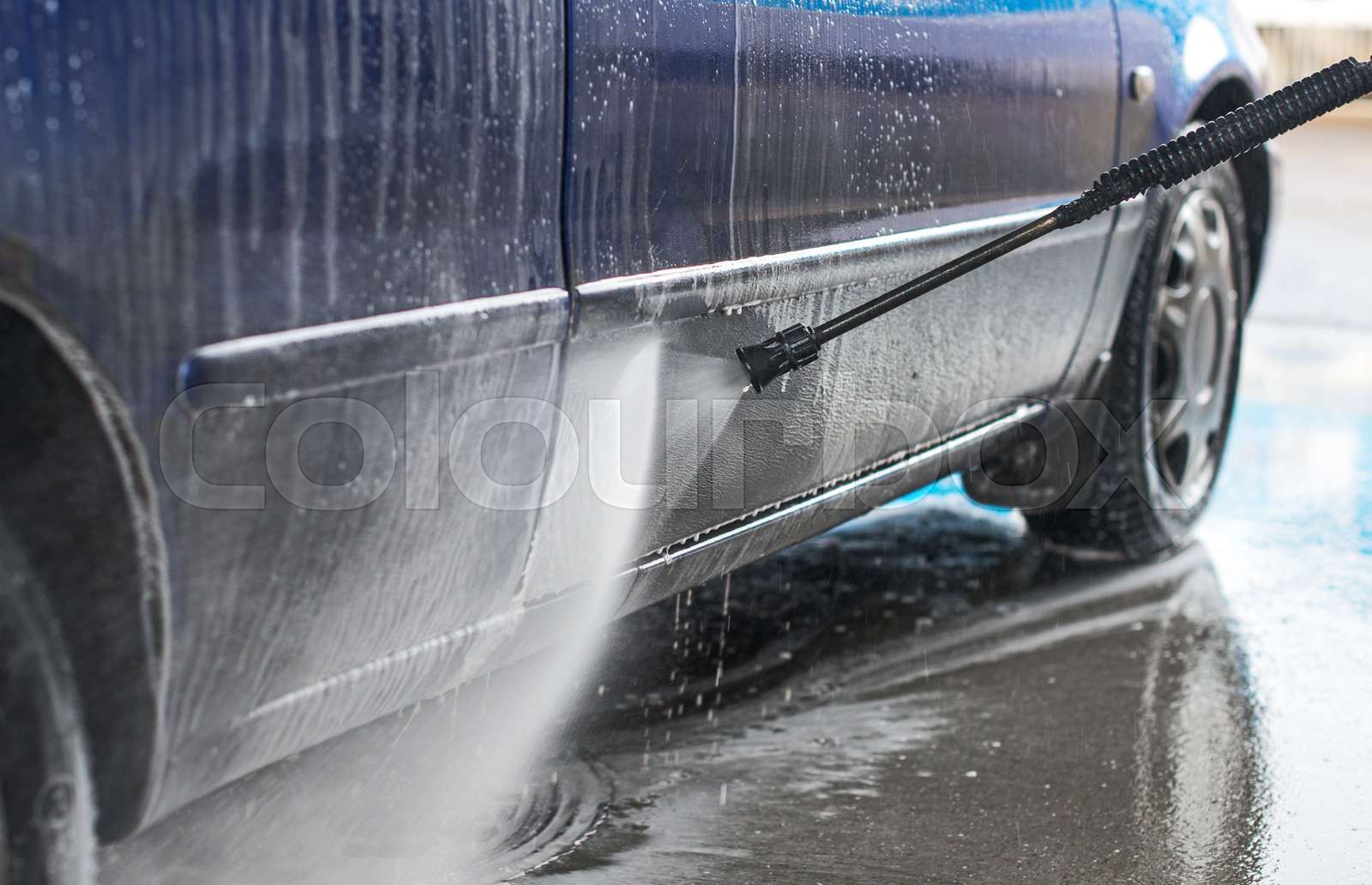 Blue car wash using high pressure water jet. | Stock image | Colourbox