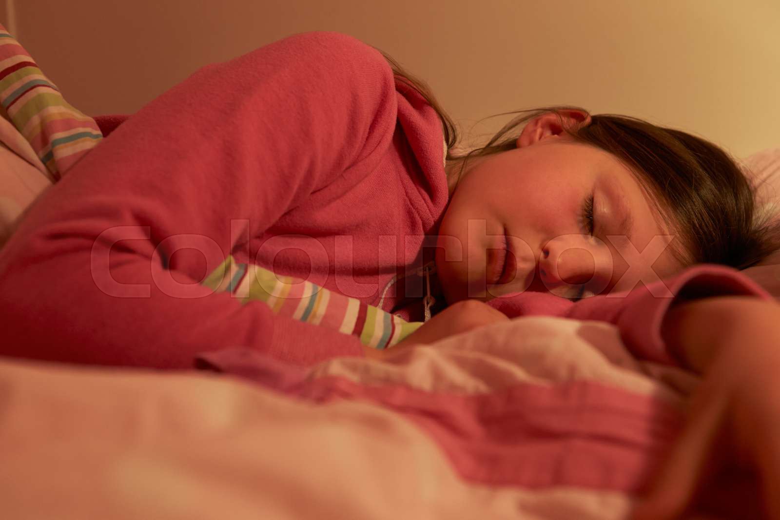 young-girl-asleep-in-bed-at-night-stock-image-colourbox