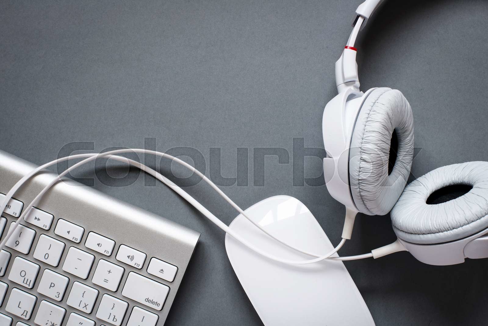 White Headphones, Keyboard and Mouse on Grey Desk Stock image Colourbox