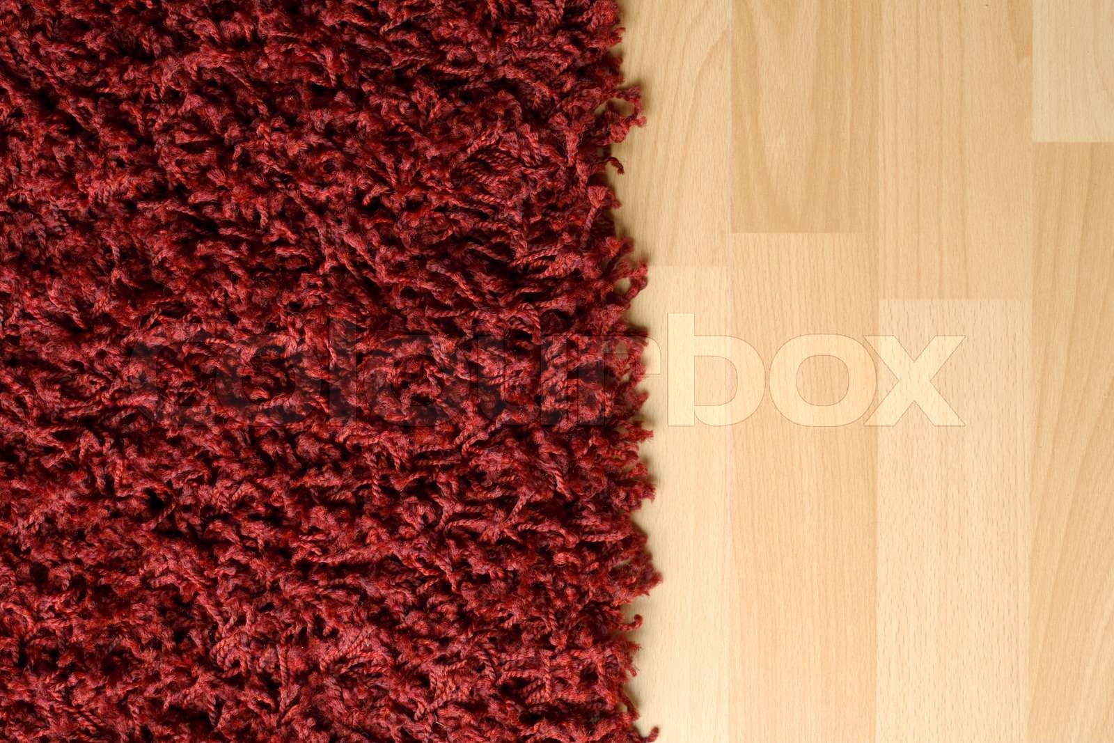 Red fluffy rug on laminate floor Stock image Colourbox