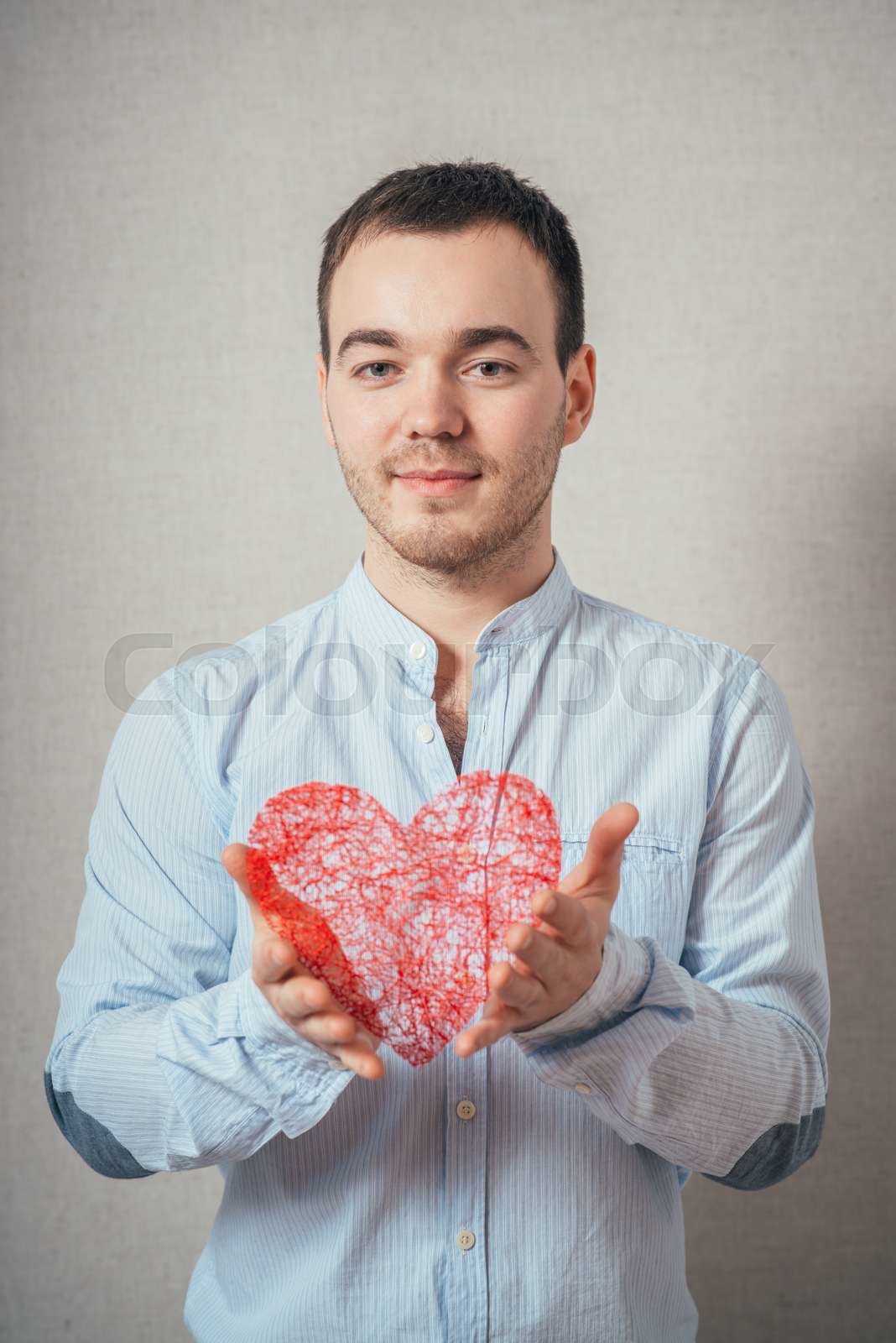 young man holding a heart Stock image Colourbox