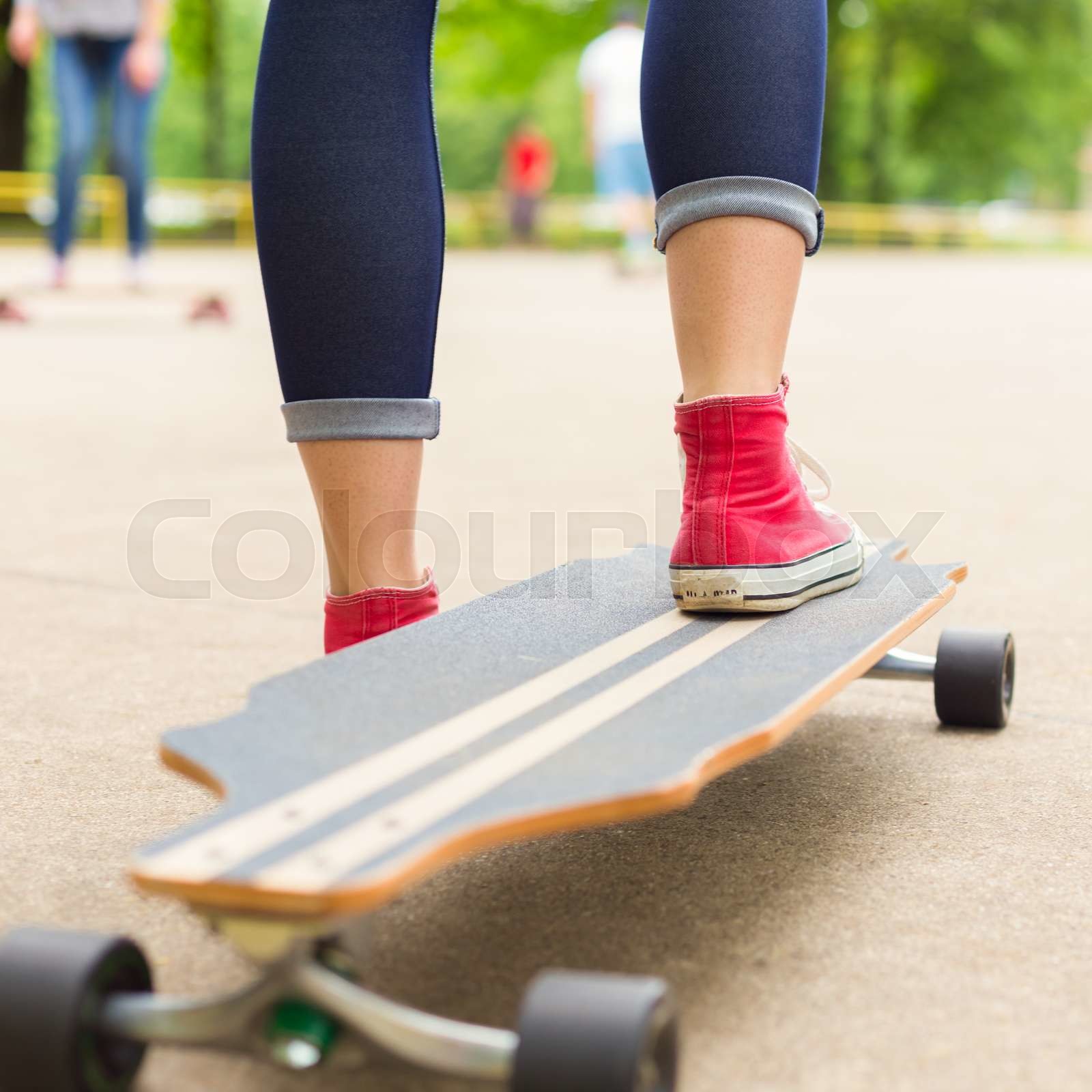 Girl practicing urban long board riding. | Stock image | Colourbox