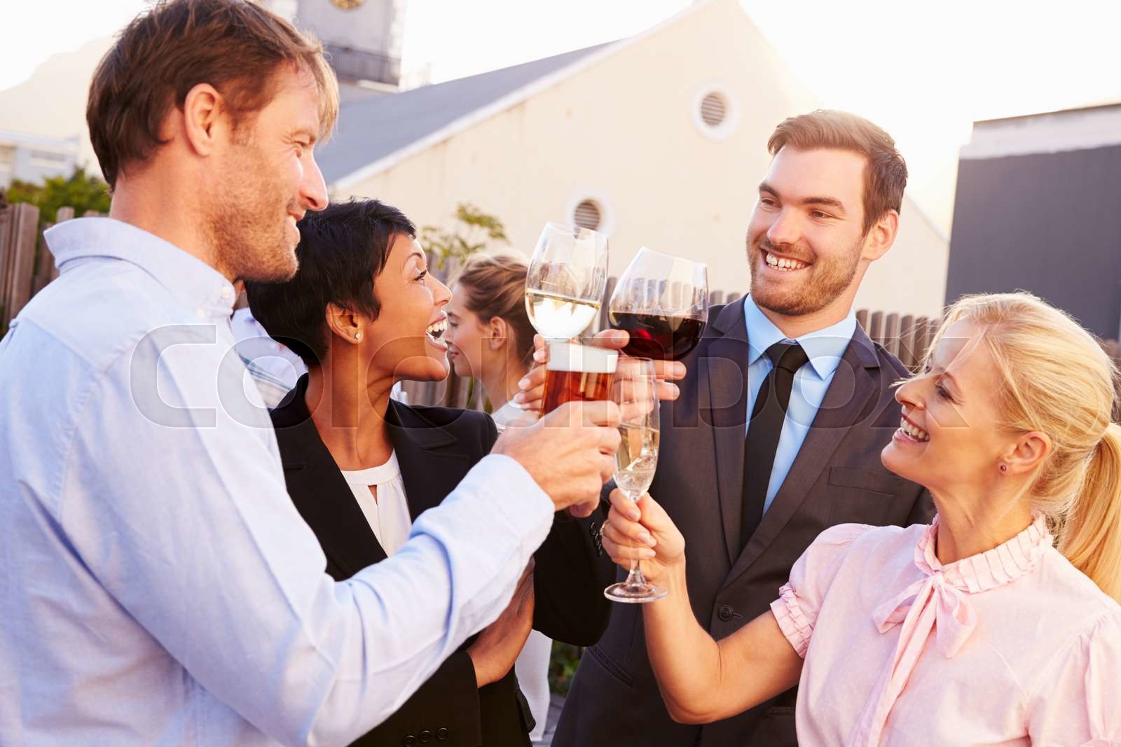 Colleagues drinking after work at a rooftop bar Stock image Colourbox