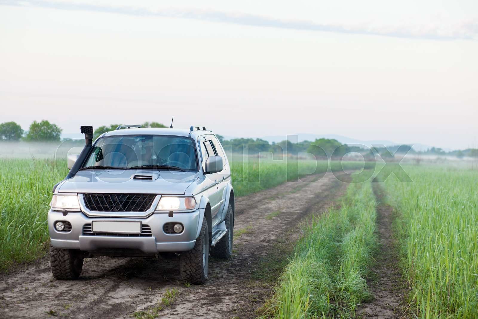 4x4 SUV with snorkel in a field Stock image Colourbox