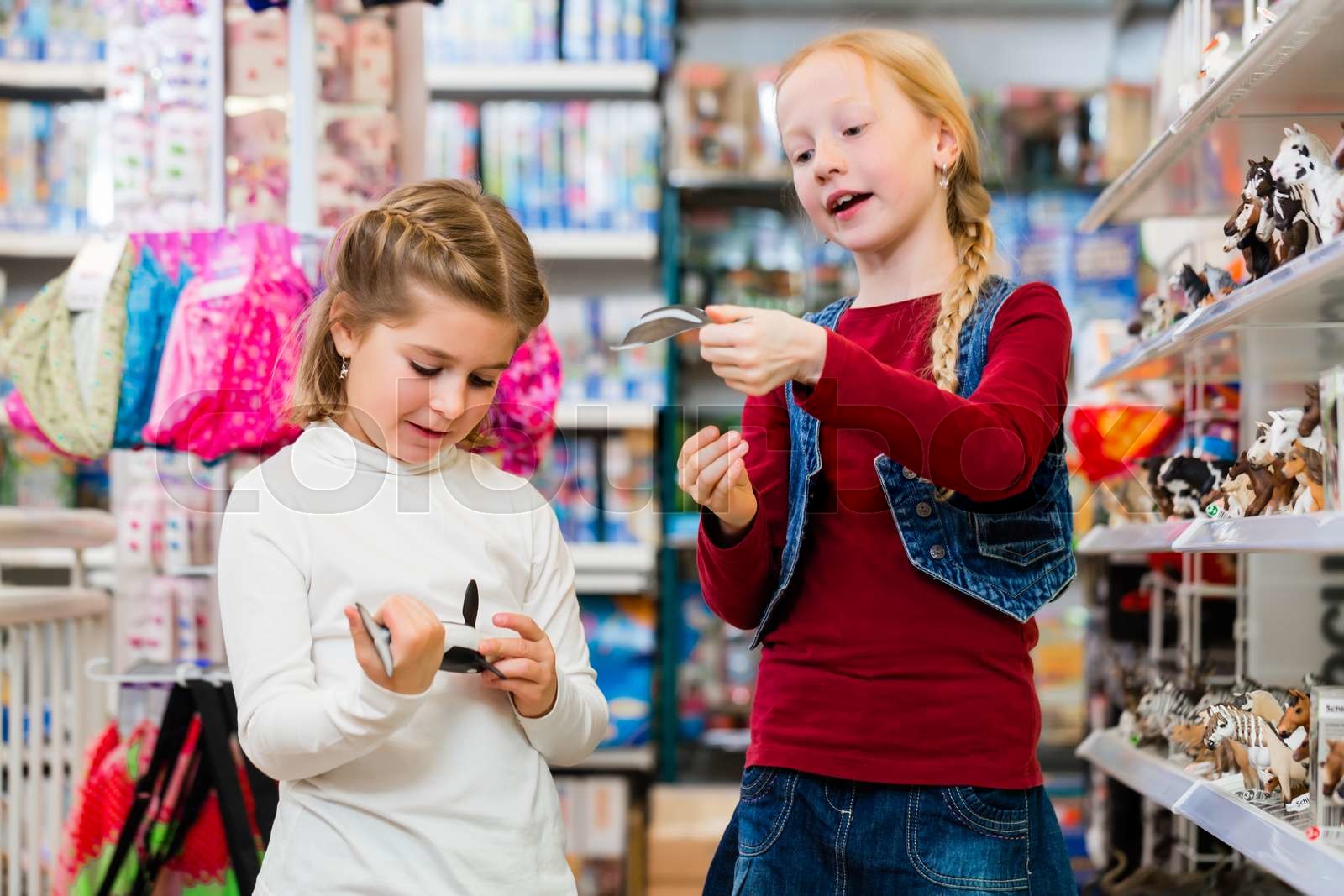 Two kids buying toys in toy store Stock image Colourbox