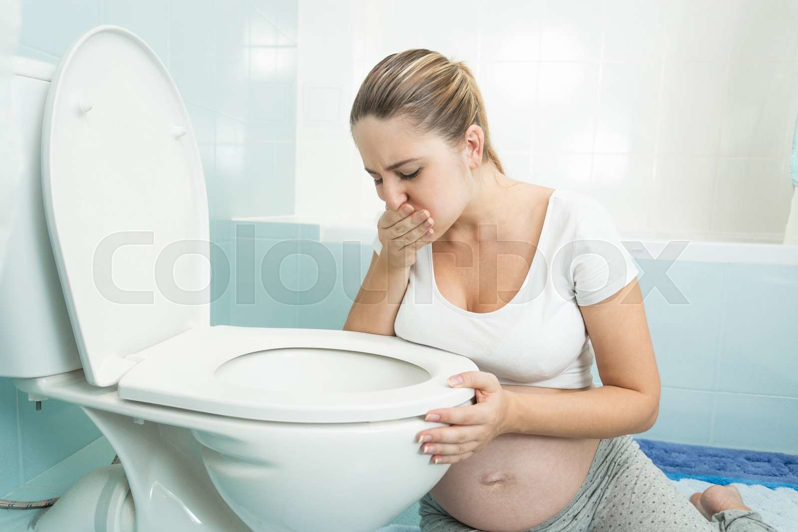 pregnant woman feeling sick at bathroom Stock image Colourbox