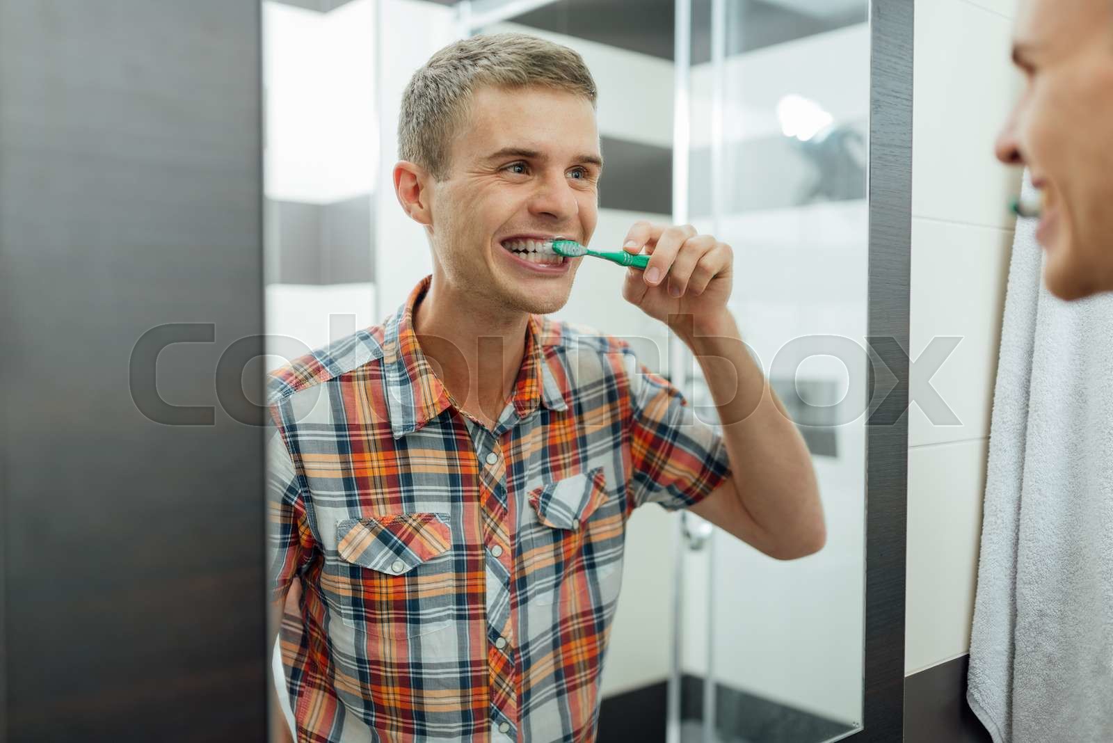 man cleans teeth in the bathroom | Stock image | Colourbox