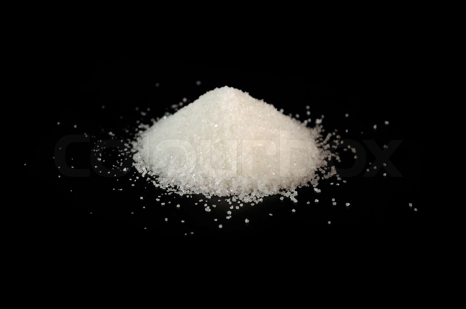 Pile af Sukker på sort baggrund | Stock foto | Colourbox