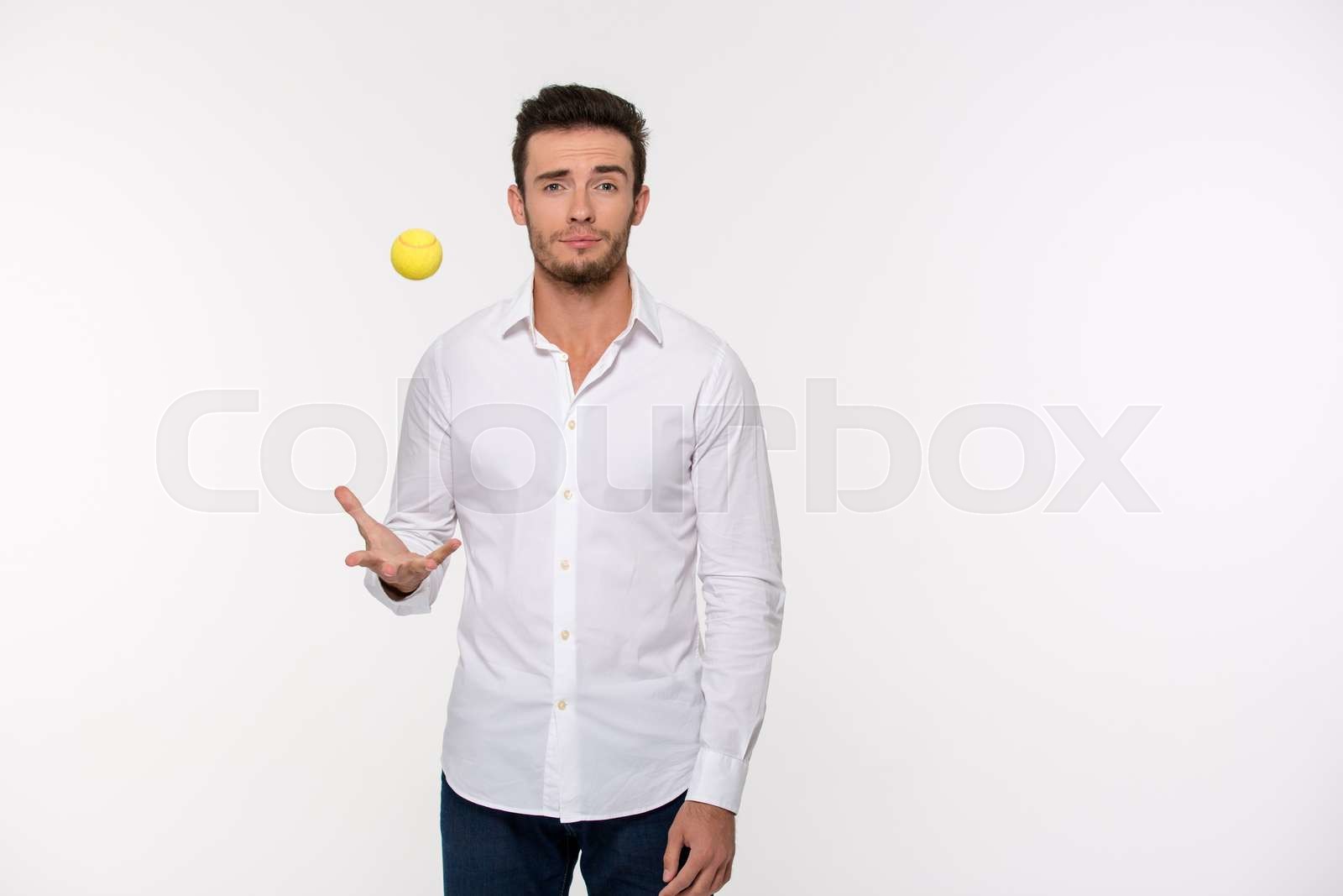 Handsome man throwing tennis ball Stock image Colourbox