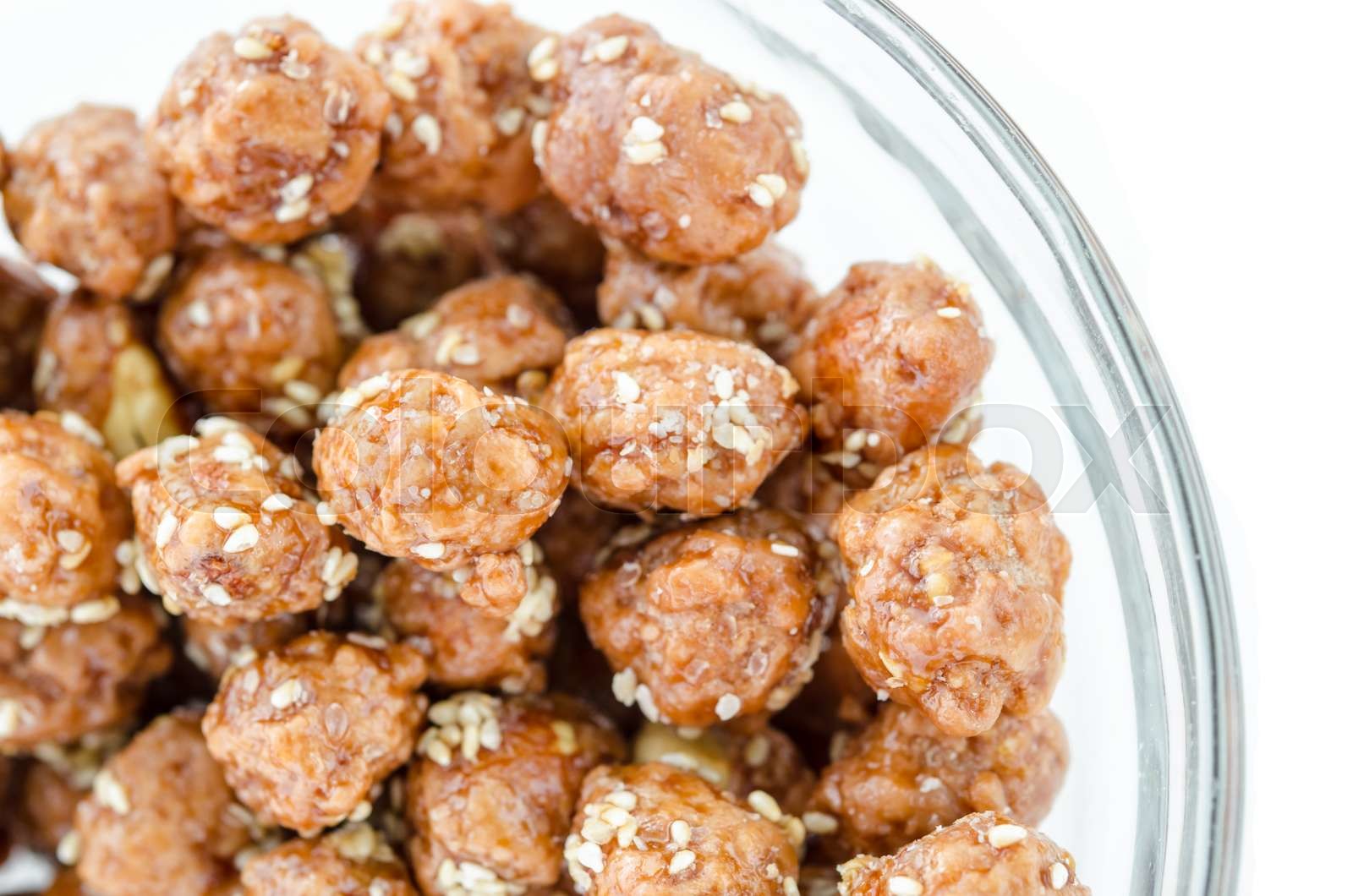 Honey roasted coated peanuts and white sesame seeds. Stock image