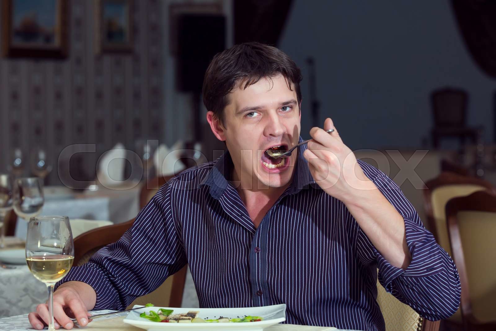 young man having dinner in a restaurant | Stock image | Colourbox