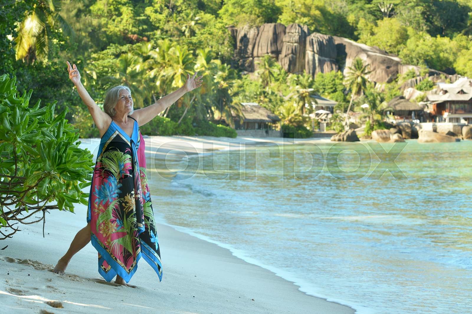 Elderly woman on beach | Stock image | Colourbox