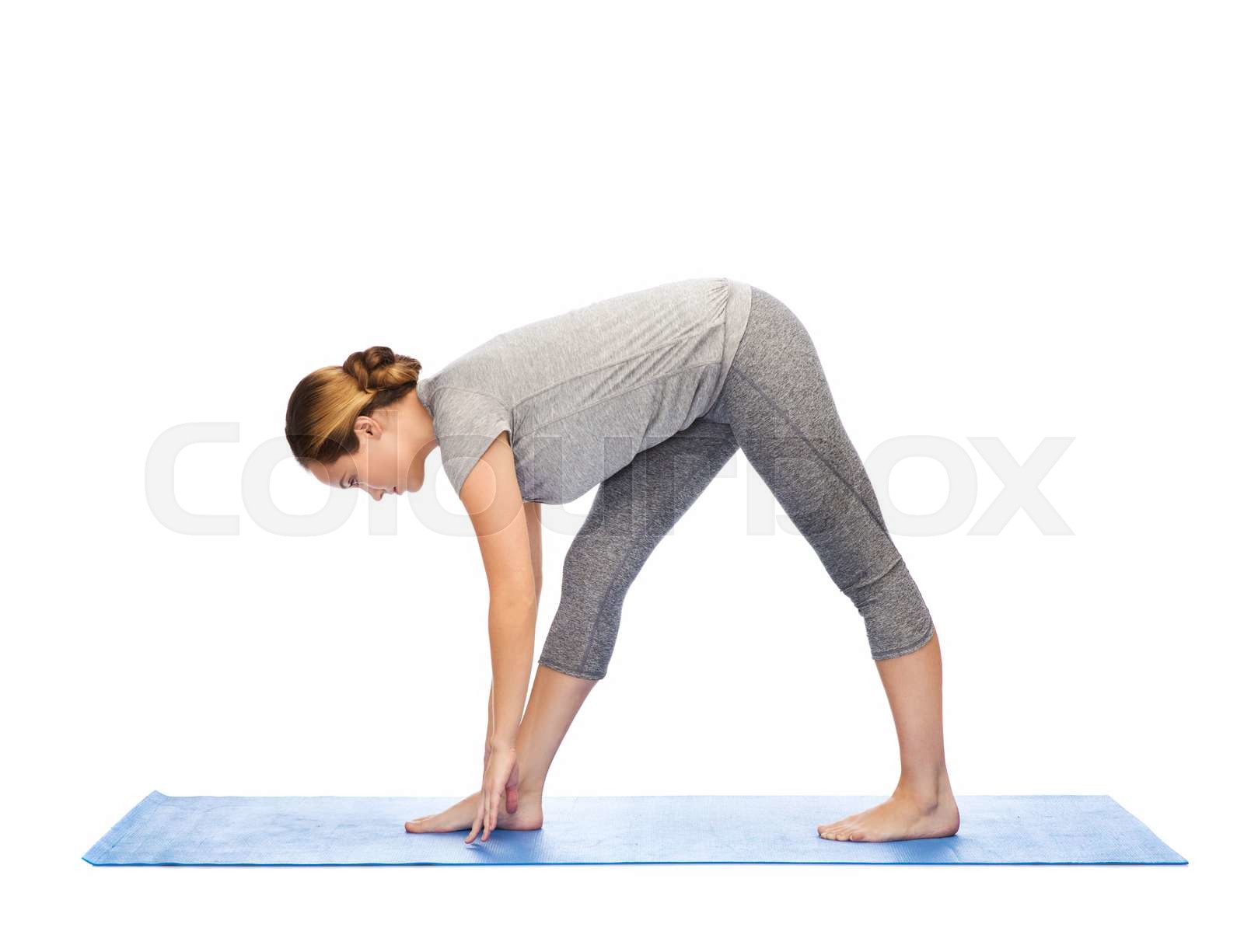 person doing yoga stretches on a mat