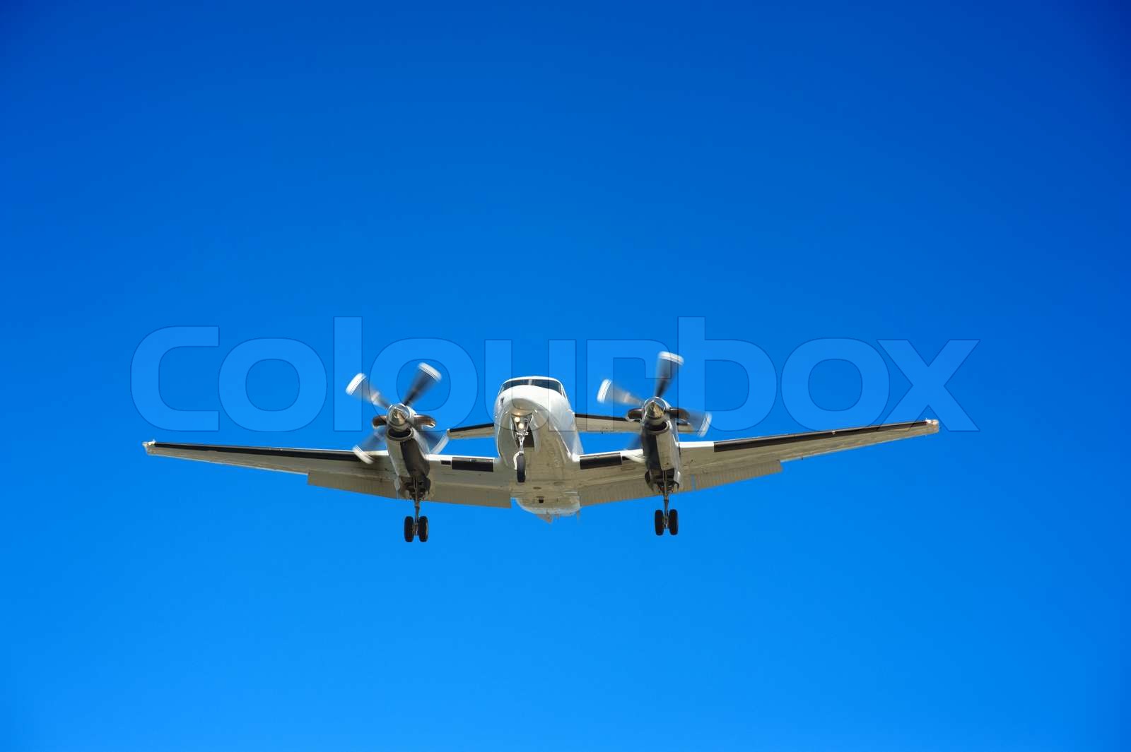 Twin engine propeller airplane approaching for landing | Stock image ...
