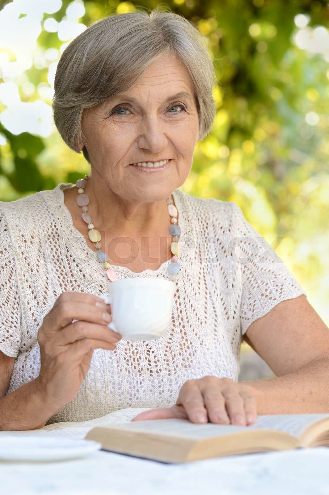 Middleaged woman drink tea Stock image