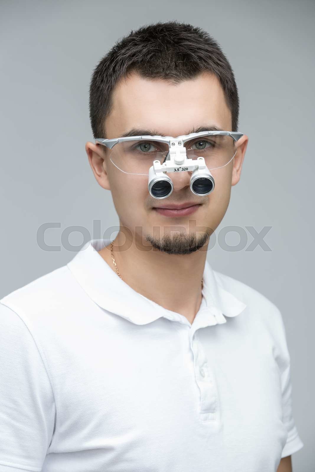 Doctor with binocular loupes Stock image Colourbox