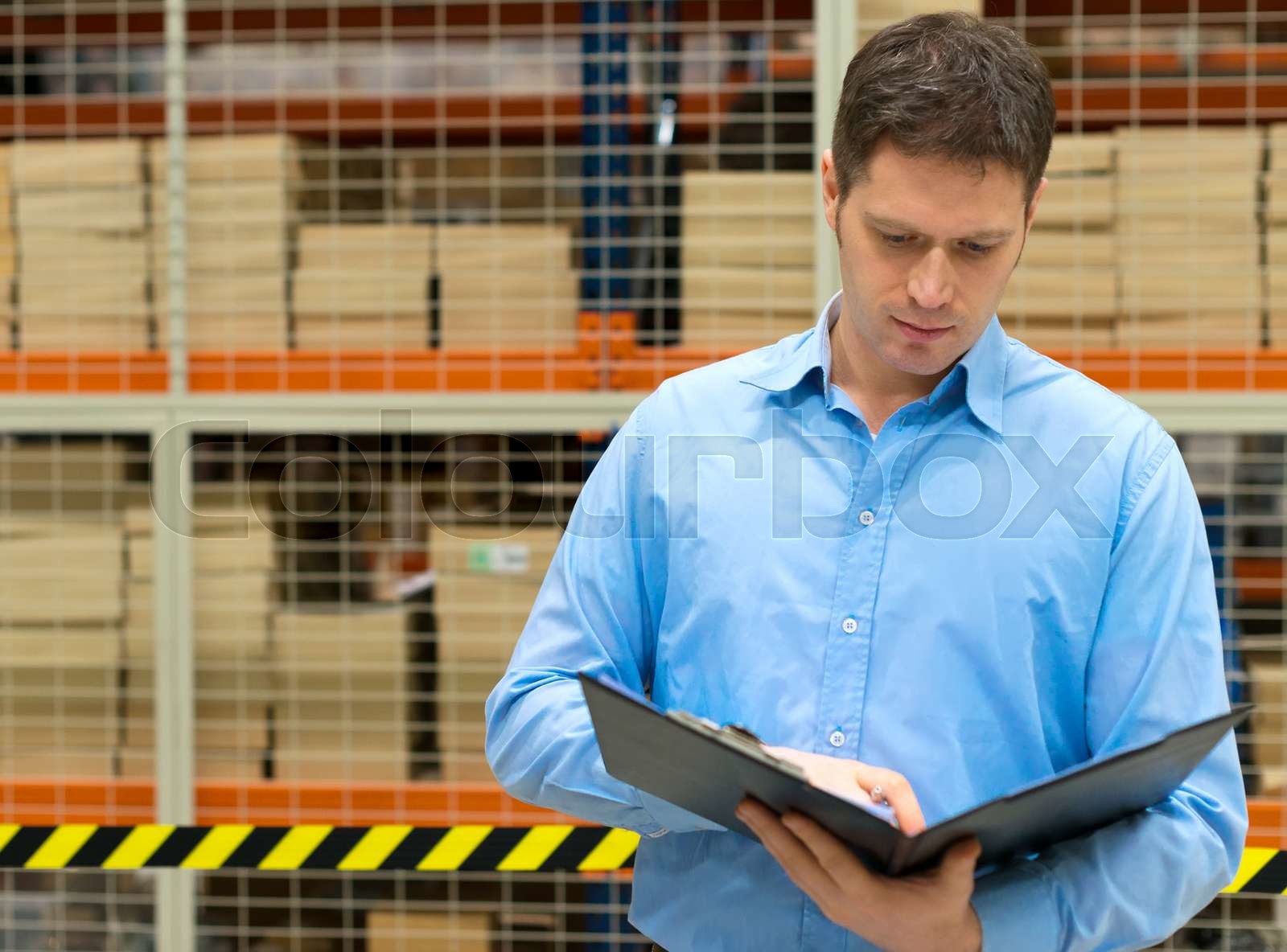 Handsome Manager With Clipboard In Post Office Stock Image Colourbox