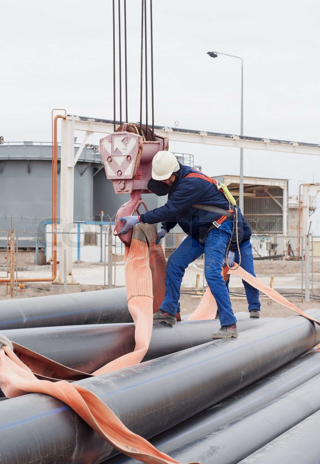 crane works (pipes unloading) | Stock image | Colourbox
