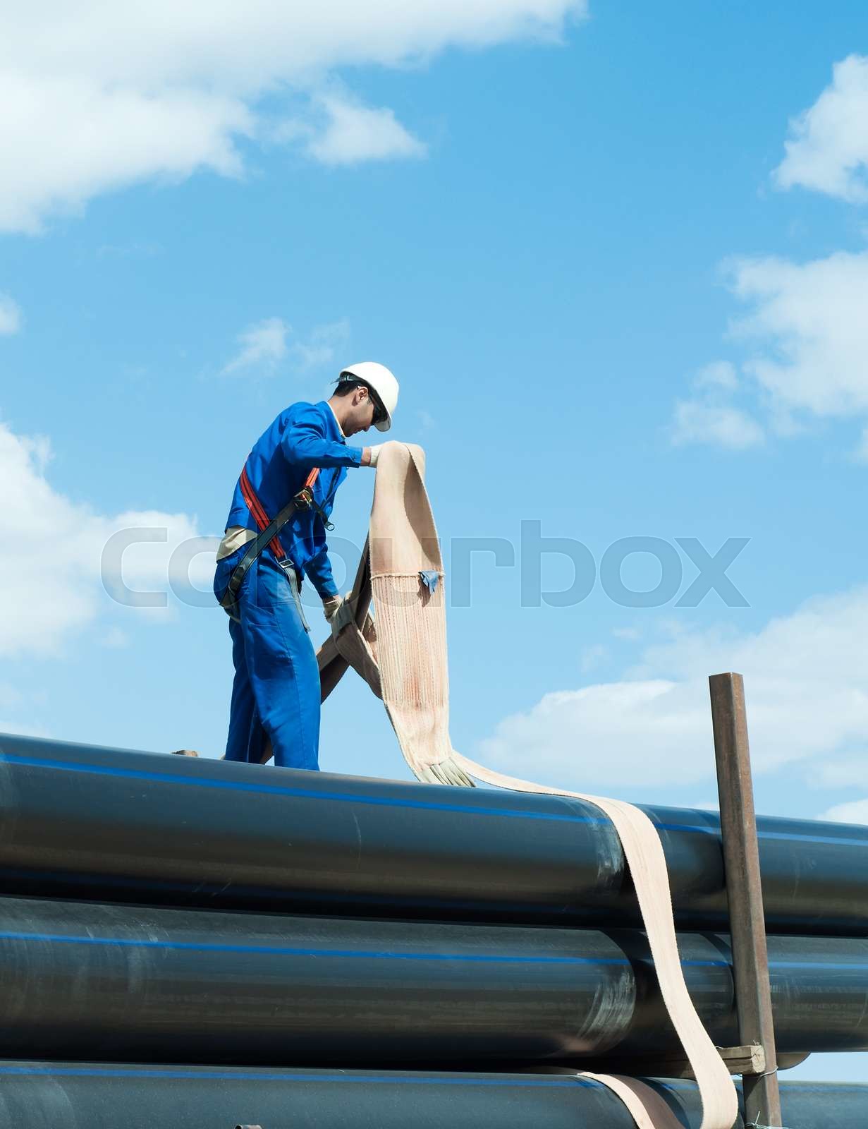 crane works (pipes unloading) | Stock image | Colourbox