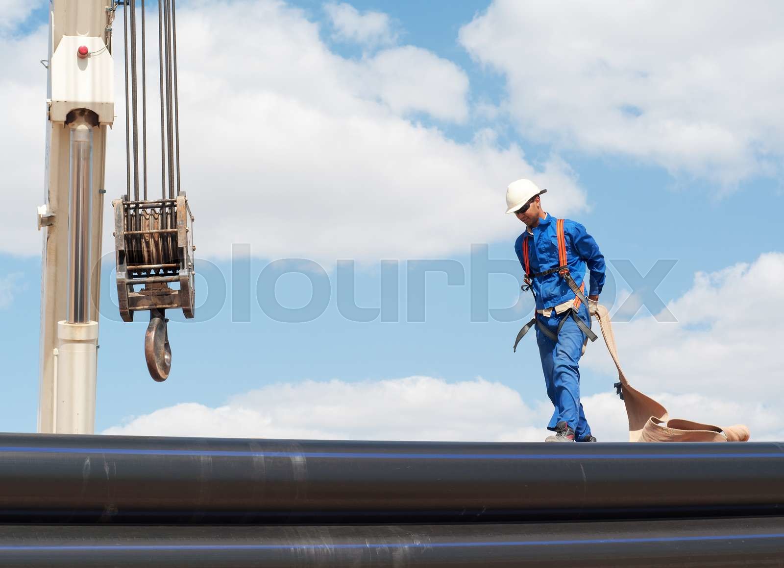 crane works (pipes unloading) | Stock image | Colourbox