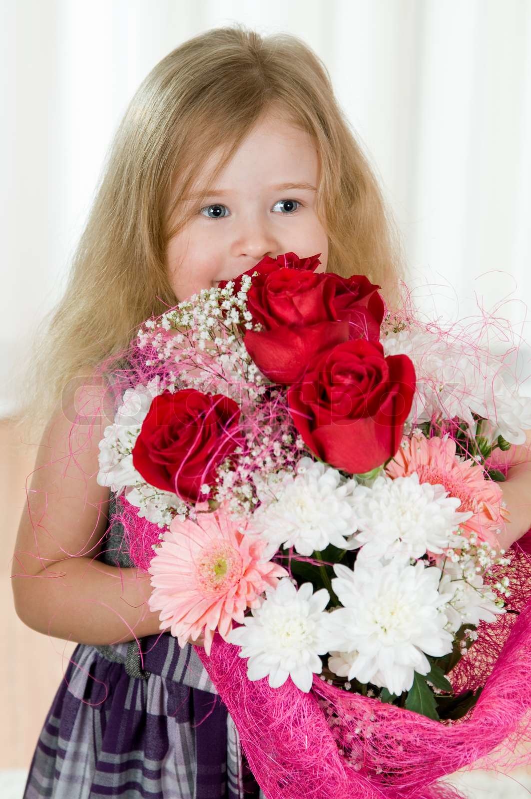 beautiful little girl with a bouquet of flowers | Stock image | Colourbox