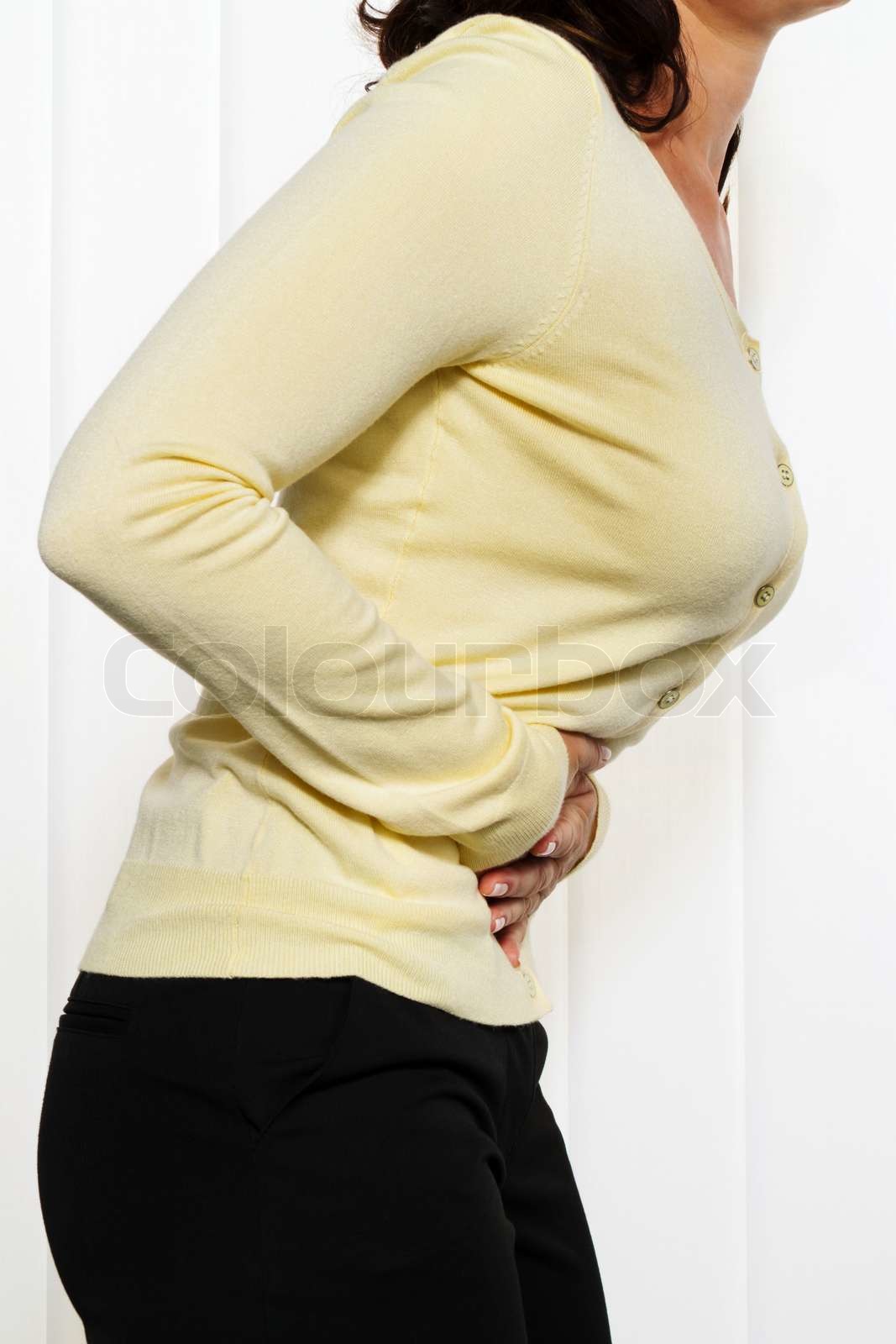 Frau mit Schmerzen im Unterleib und Leistengegend. Stock Bild Colourbox