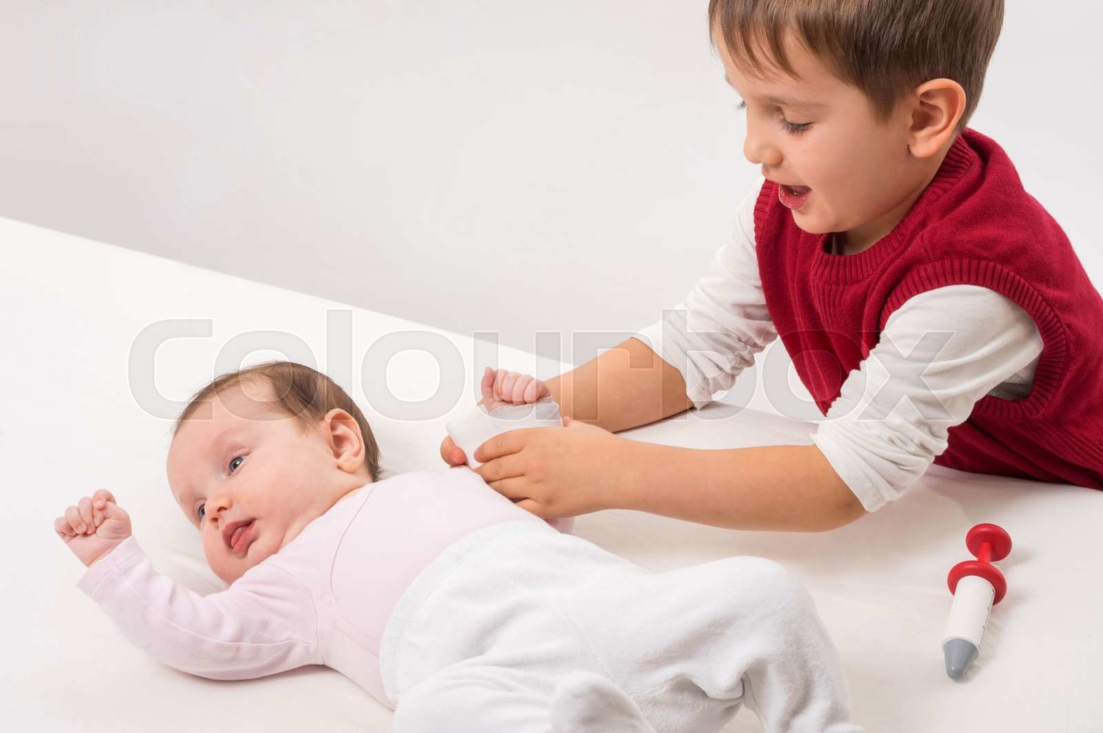 Elder sister and brother play doctor