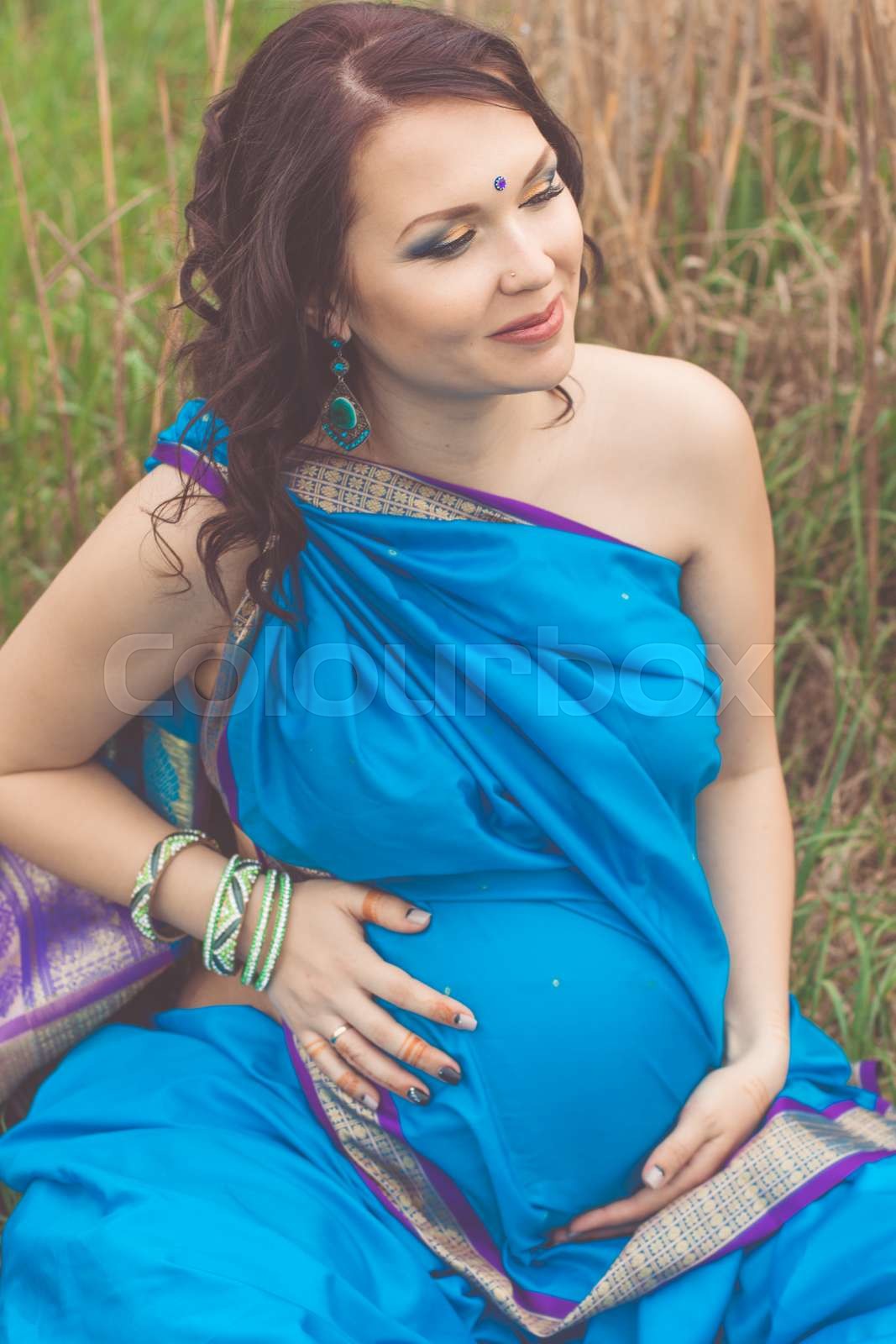Pregnant indian girl is wearing blue sari | Stock image | Colourbox